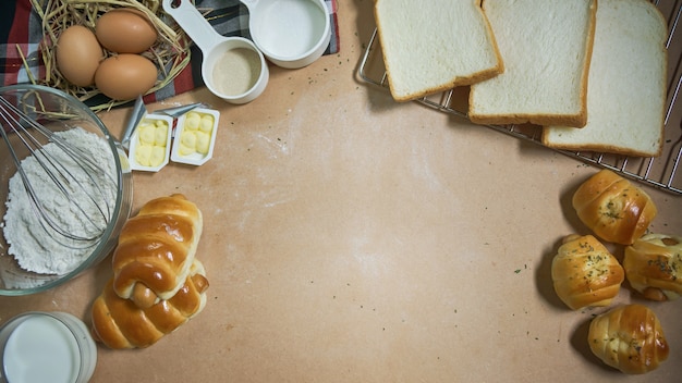 Fresh bread and ingredients on wood table 