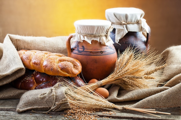 Fresh bread on an old background with kitchen accessories on the table.