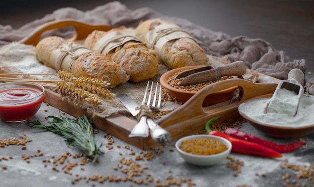 Fresh bread on an old background with kitchen accessories on the table