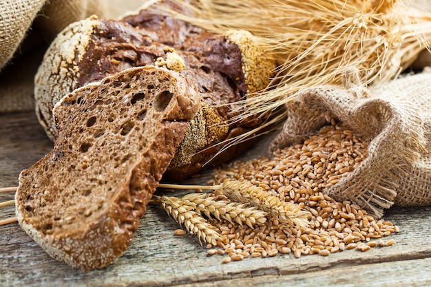 Fresh bread on an old background with kitchen accessories on the table