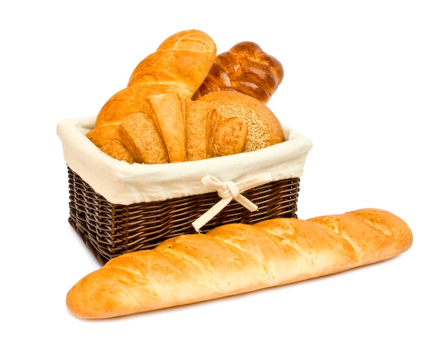 Fresh bread rolls in a basket on whitete