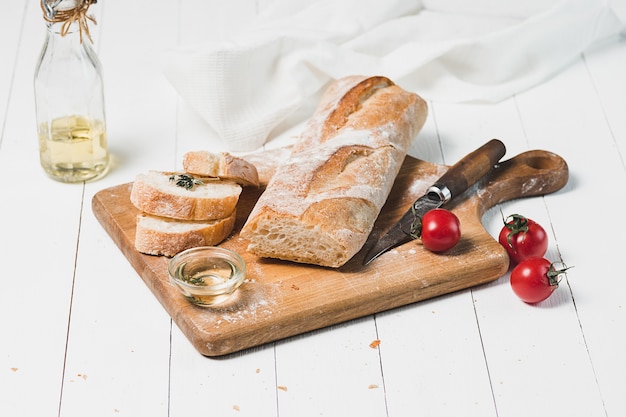 Fresh bread on table close-up. Fresh bread on the kitchen table The healthy eating and traditional bakery concept. Rustic style, front view