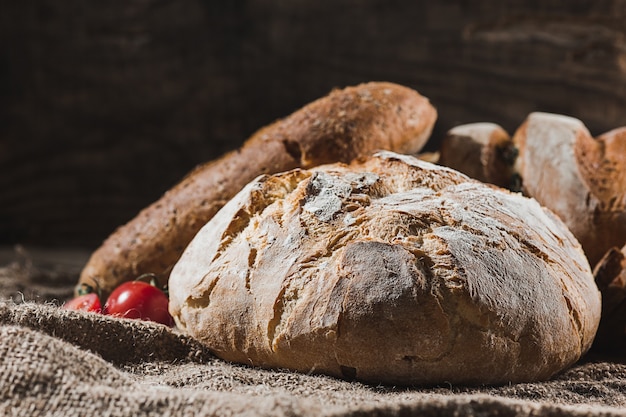 Fresh bread on table close-up. Fresh bread on the kitchen table The healthy eating and traditional bakery concept. Rustic style