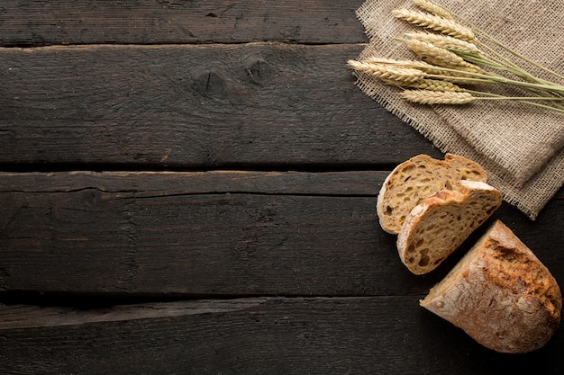 fresh bread and wheat on wood