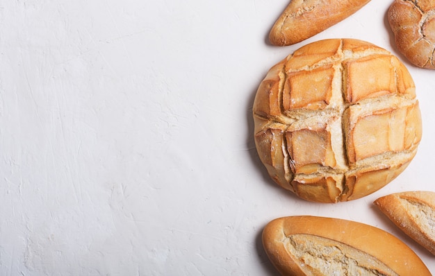 Fresh bread on a white background. Top view with copy space