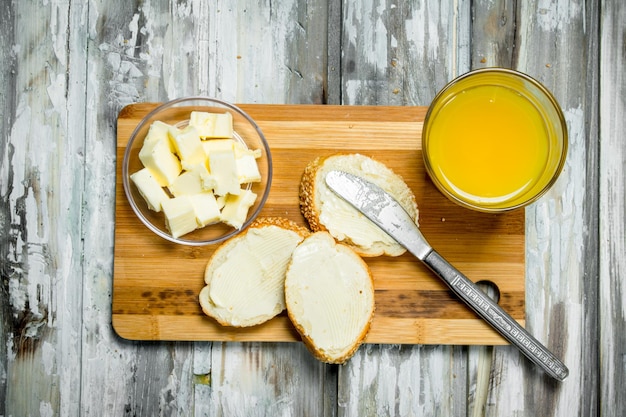 Fresh bread with butter and orange juice