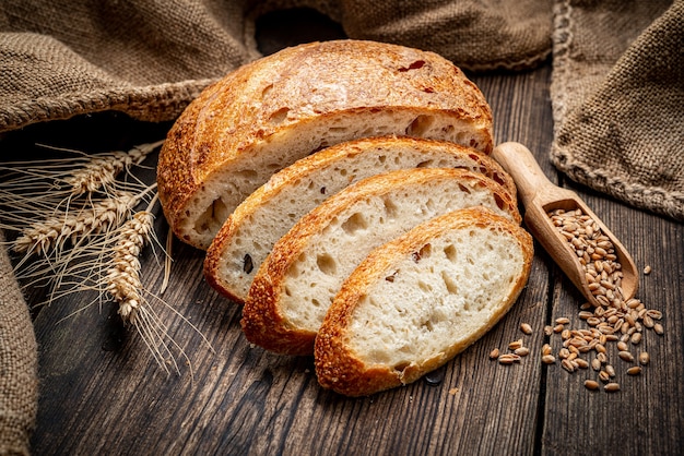 Fresh bread on wooden ground. Freshly baked traditional bread on wooden table. Healthy food