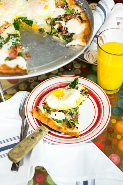 Fresh breakfast pizza with three farm fresh eggs in Italian restaurant.