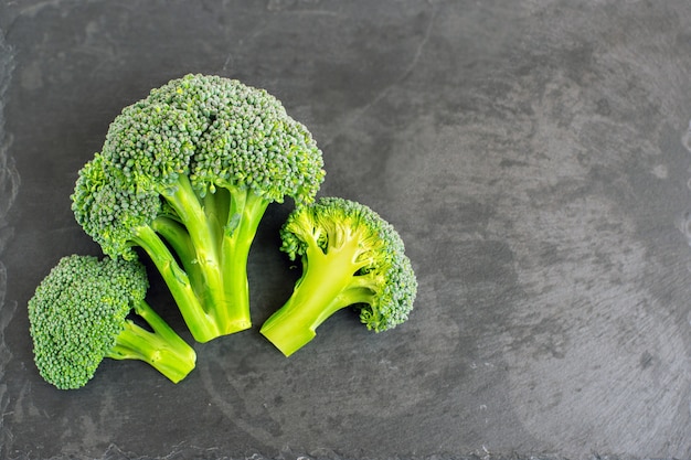 Fresh broccoli on black background. Top view