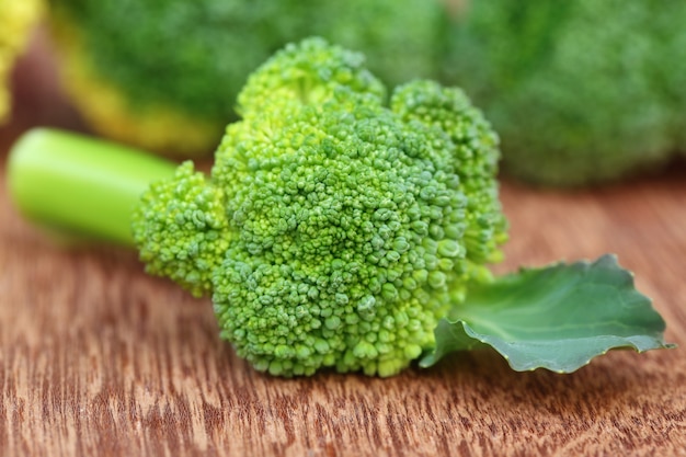 Fresh Broccoli with leaf over wooden surface