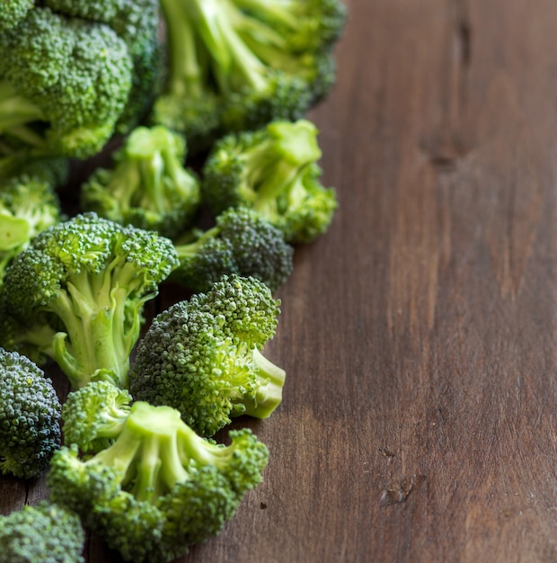 Fresh broccoli on wooden table close up with copy space