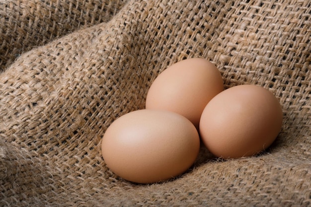 Fresh brown eggs on a bag Natural crude products