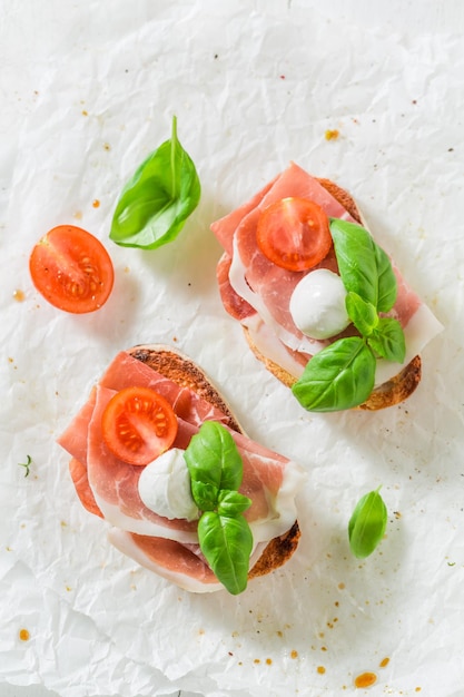 Fresh bruschetta with prosciutto tomato and mozzarella for a snack