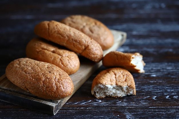 Fresh buns with bran on a wooden surface Wholemeal bread