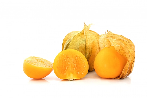 Fresh Cape gooseberry fruit on white surface