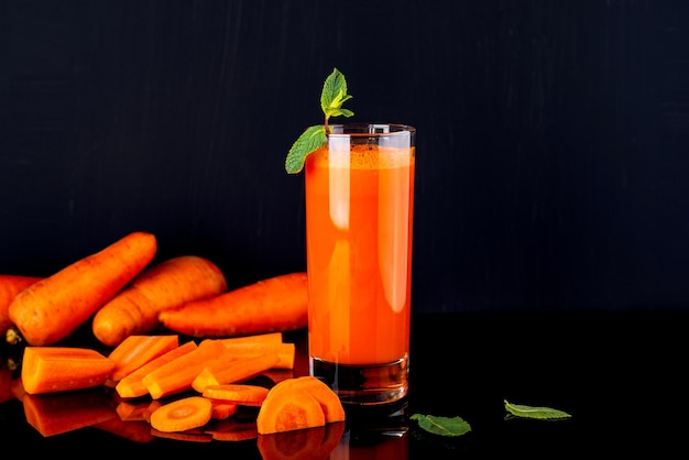 Fresh carrot juice Carrot drink on a black background Copy space