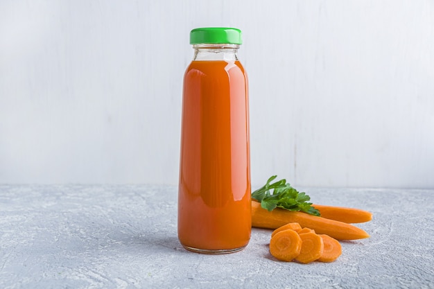 Fresh carrot juice in glass bottle