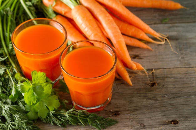 Fresh carrot smoothie in two glasses