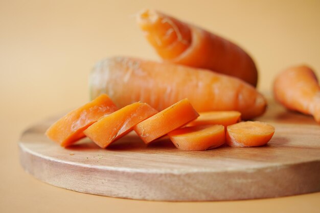 Fresh carrots on chopping board on table