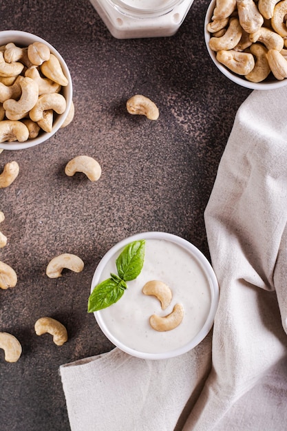 Fresh cashew sauce with basil in a bowl for a vegetarian diet top and vertical view