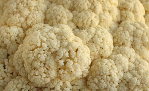 Fresh cauliflower white cabbage divided into inflorescences on a light background