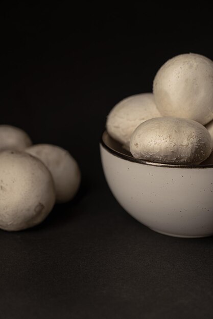 Fresh champignons on a dark background ready to cook