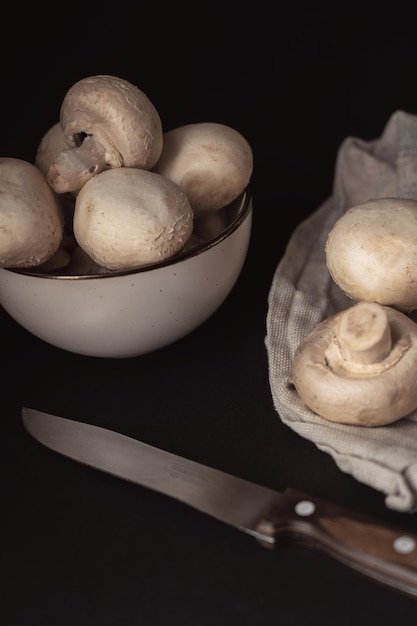 Fresh champignons on a dark background ready to cook