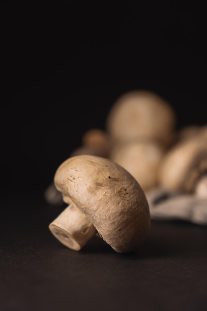 Fresh champignons on a dark background ready to cook