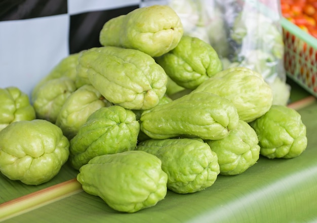 Fresh chayote fruits Sechium edulis on leaf background Chayote or sweet gourd Cucurbitaceae