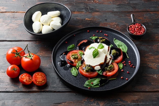 Fresh cheese served with fresh tomatoes and basil leaves