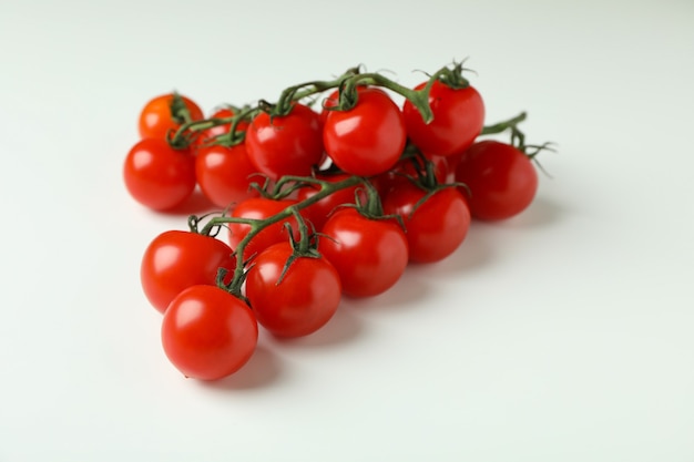 Fresh cherry tomato branches on white background