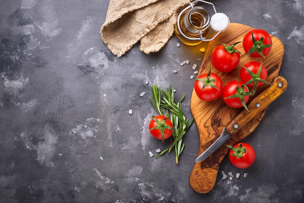 Fresh cherry tomatoes on grey table