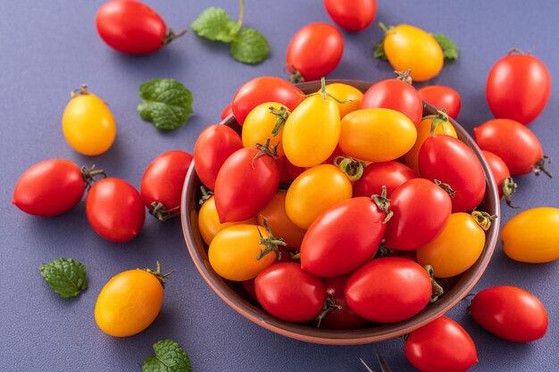 Fresh cherry tomatoes in a wooden bowl 