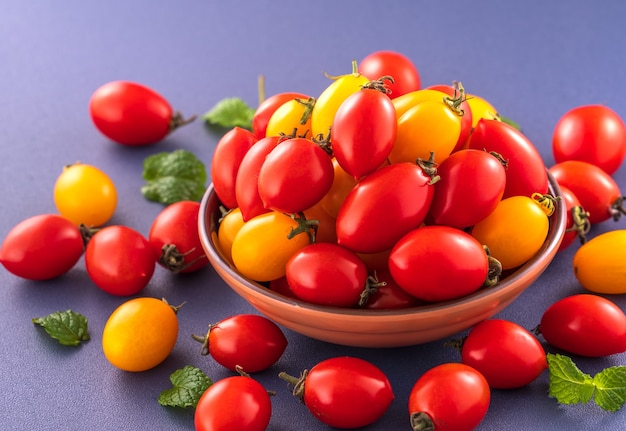 Fresh cherry tomatoes in a wooden bowl 