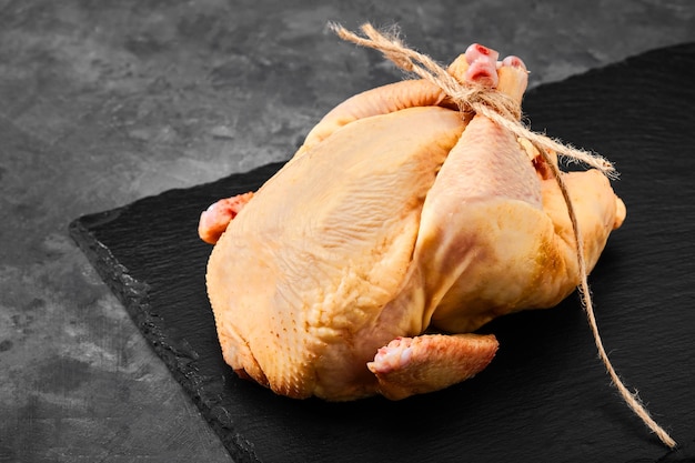 Fresh chicken carcass meat on cutting board