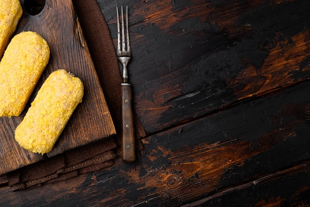 Fresh chicken cutlets prepared for frying set, on old dark  wooden table background, top view flat lay, with copy space for text