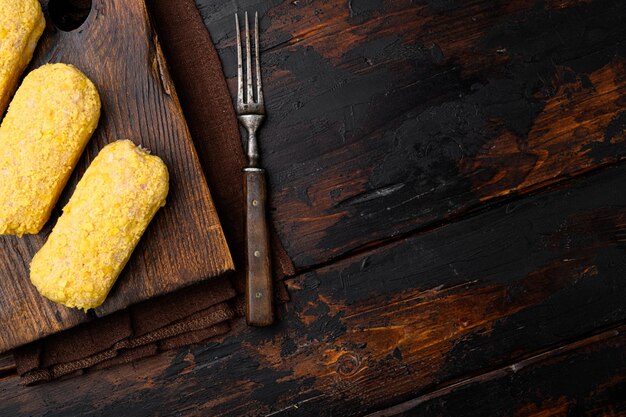 Fresh chicken cutlets prepared for frying set, on old dark  wooden table background, top view flat lay, with copy space for text