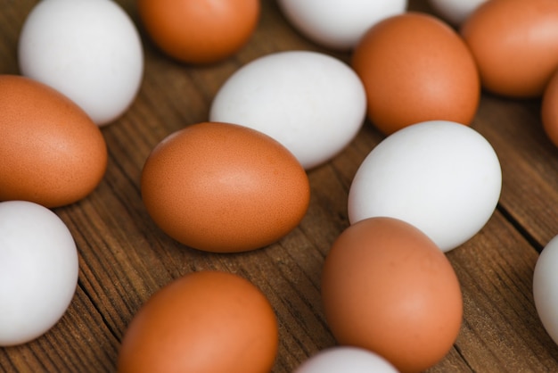 Fresh Chicken eggs and duck eggs on wooden background, white and brown egg nature from farm