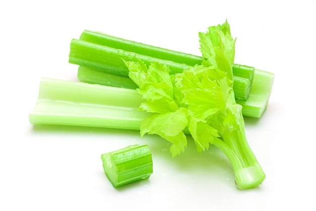 Fresh Chopped Celery Sticks and Slices with Leaves and Water Drops Isolated on White Background