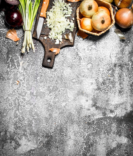 Fresh chopped onion on the old Board. On rustic table.