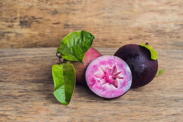 Fresh Chrysophyllum cainito fruits on wooden table