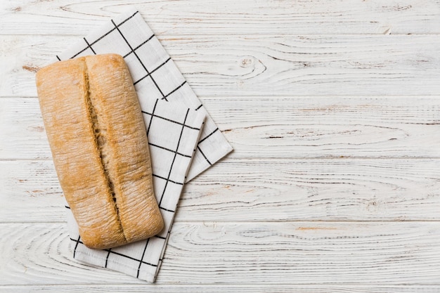 Fresh ciabatta bread on napkin on rustic background Italian bread top view