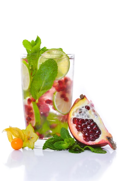 A fresh cocktail of tropical fruit and juice with ice Fresh fruit lime lemon mint kiwi Top view On a white background