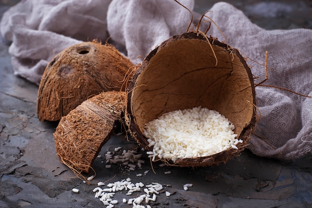 Fresh coconut flakes on grey background