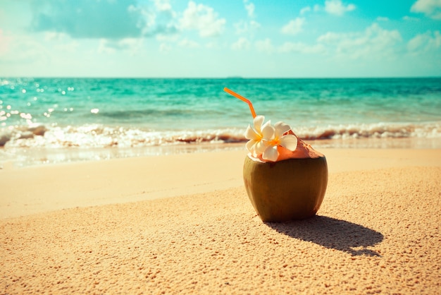 Fresh coconut juice on a beach