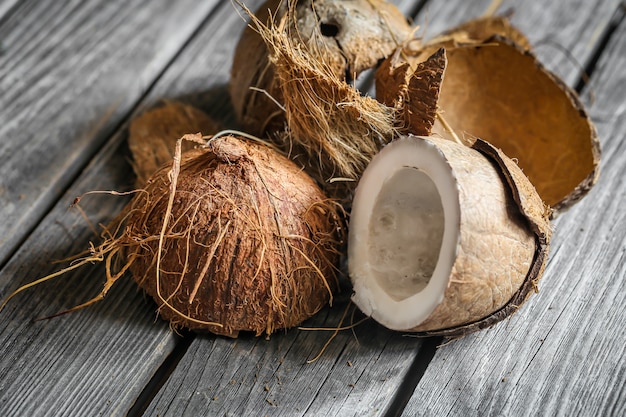 Fresh coconuts broken on wooden table