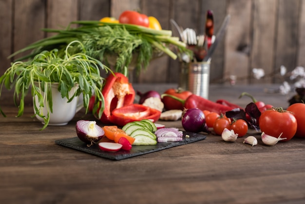 Fresh colorful vegetables from a kitchen garden on a dark wooden background