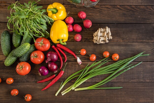 Fresh colorful vegetables from a kitchen garden on a dark wooden background