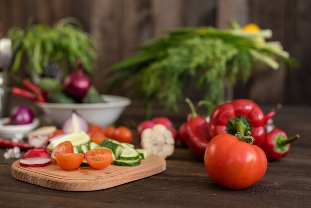 Fresh colorful vegetables from a kitchen garden on a dark wooden background