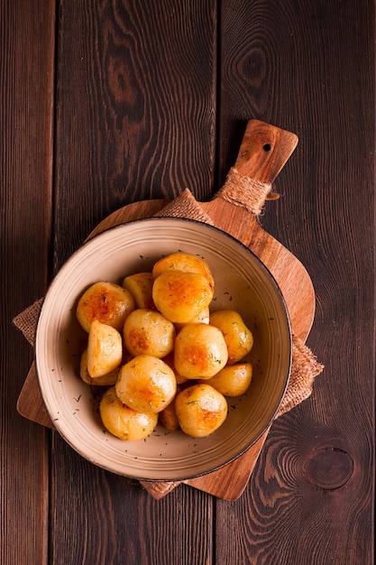 Fresh Cooked new potatoeswith dill on a wooden table selective focus closeup toning no people